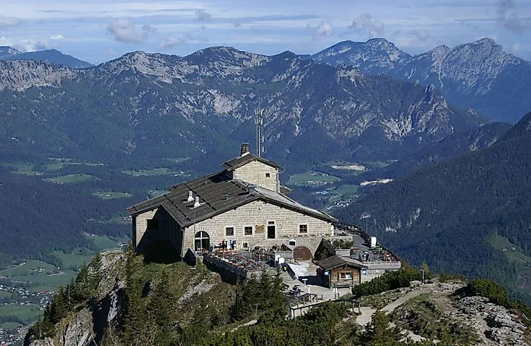 Historisches Kehlsteinhaus in Berchtesgaden auf einem Berggipfel mit weitem Alpenpanorama im Hintergrund.