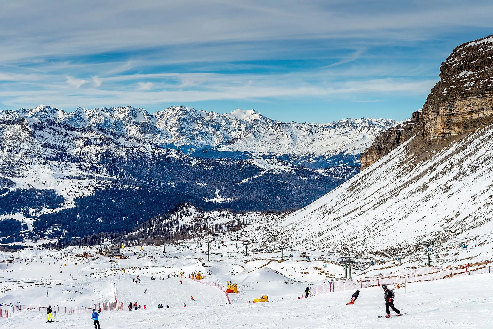 Skifahrer auf den verschneiten Pisten von Madonna di Campiglio im Trentino, mit Blick auf die majestätischen Dolomiten.