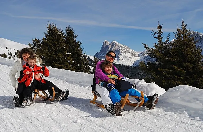 Tobogganing fun with the family in the snowy winter paradise of Brixen.